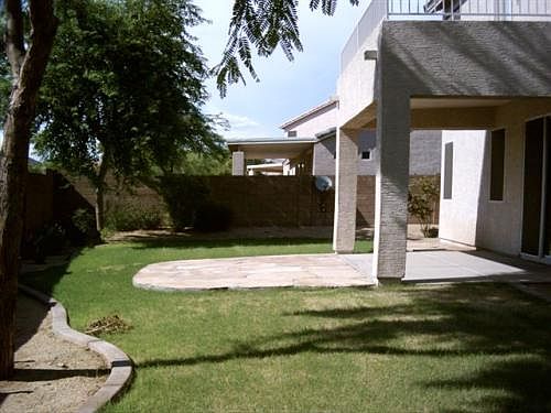 Backyard with cover patio and master bedroom balcony above