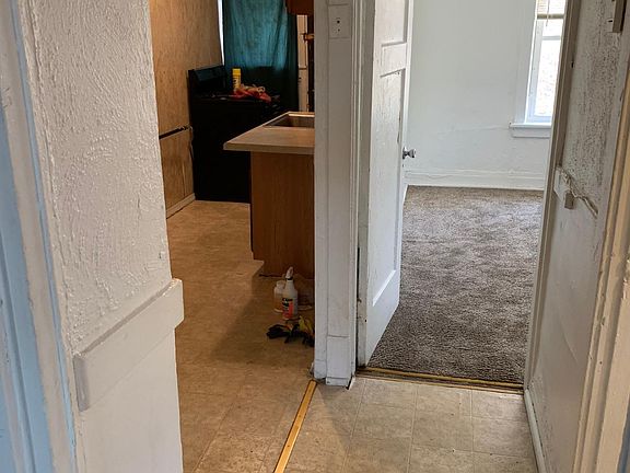 FROM SECOND ROOM TO BATHROOM ON RIGHT, BACK BEDROOM AND TO KITCHEN.