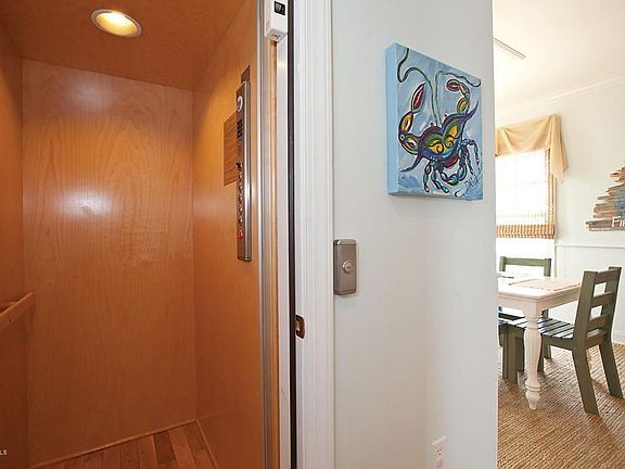 Elevator goes from carport to top floor of duplex, with stops at each level.