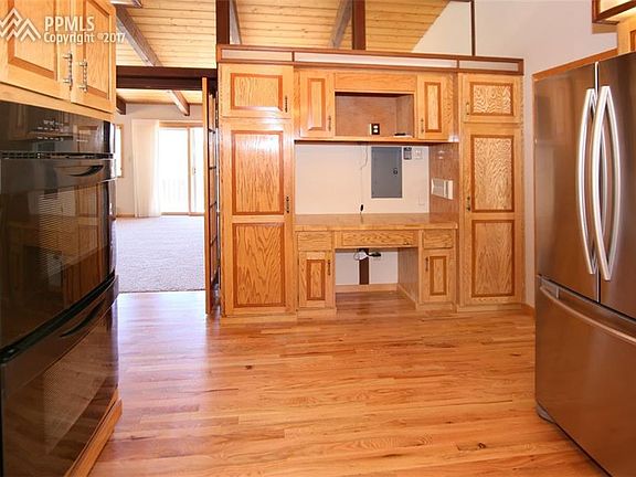 Stainless appliances, desk area with pantries, french doors to formal dining/gre