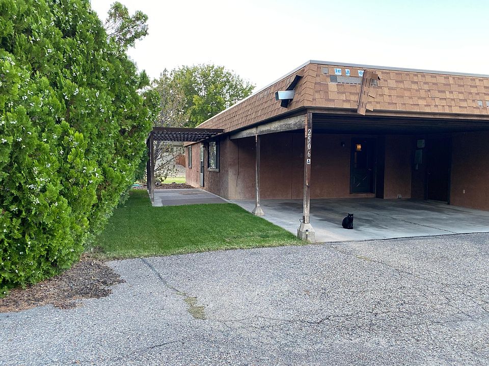 Carport, small front lawn and patio area.