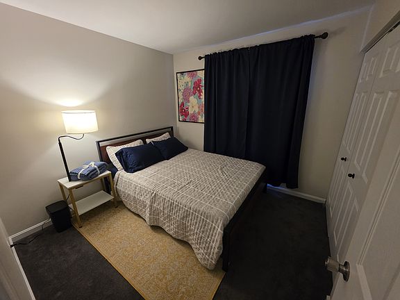 Blackout curtains, bedside table and lamp.