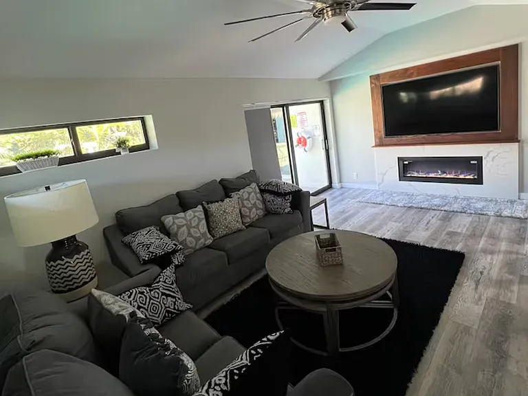 Second living room with entrance to pool area.