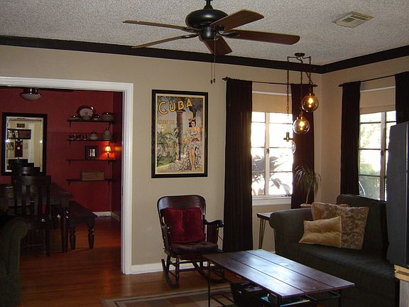 living room w/ fireplace, built in bookshelves & cabinets