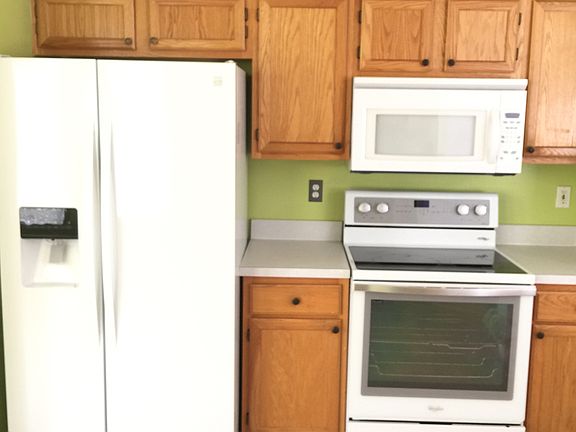Kitchen appliances includes stove, refrigerator ice/water