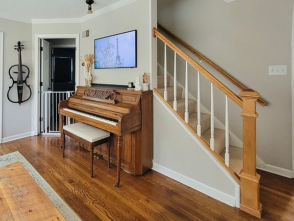 Formal living area looking to office and primary bedroom