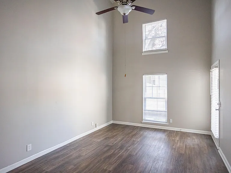 Spacious living room with hardwood-style flooring and vaulted ceiling