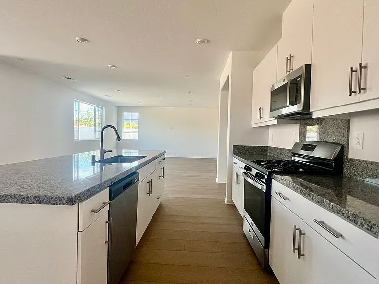 The Kitchen area opens to the living room and dining area.