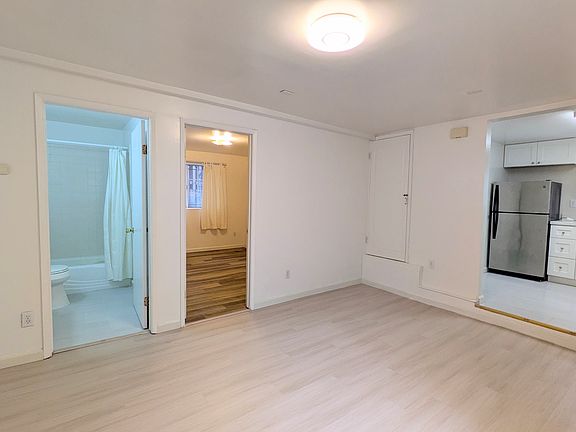Living room, with doorway to kitchen, bathroom, and bedroom