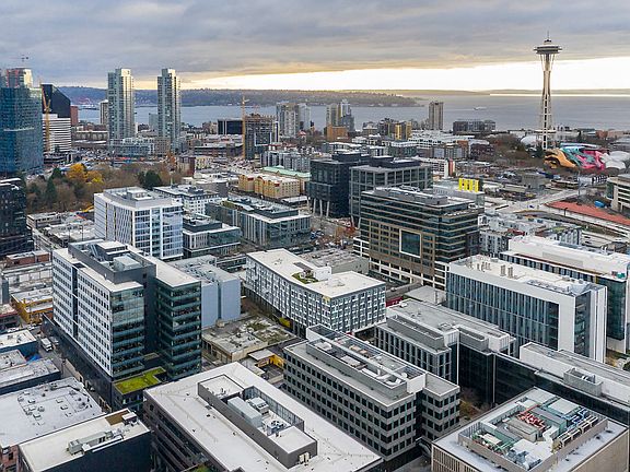 Aerial View of the buildings exterior with The Space Needle in the distance.