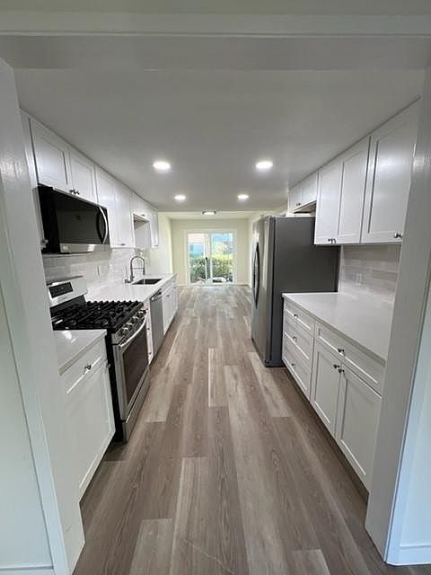 Brand new remodeled kitchen looking toward the dining room and back slider