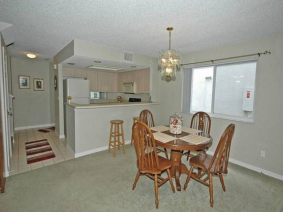 Light and bright dining area also features a breakfast bar. 
