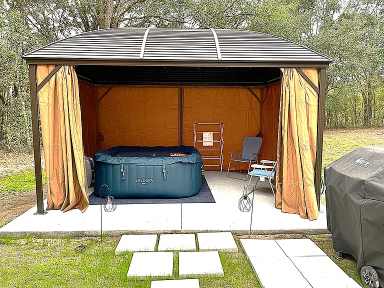 Screened Gazebo with Inflatable Hot Tub and seating.