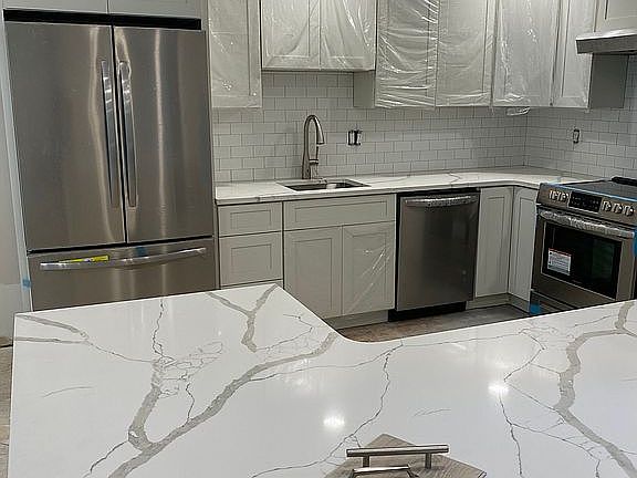 White shaker cabinets/Quartz