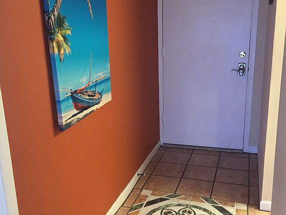 Tropical entryway with tile floors throughout