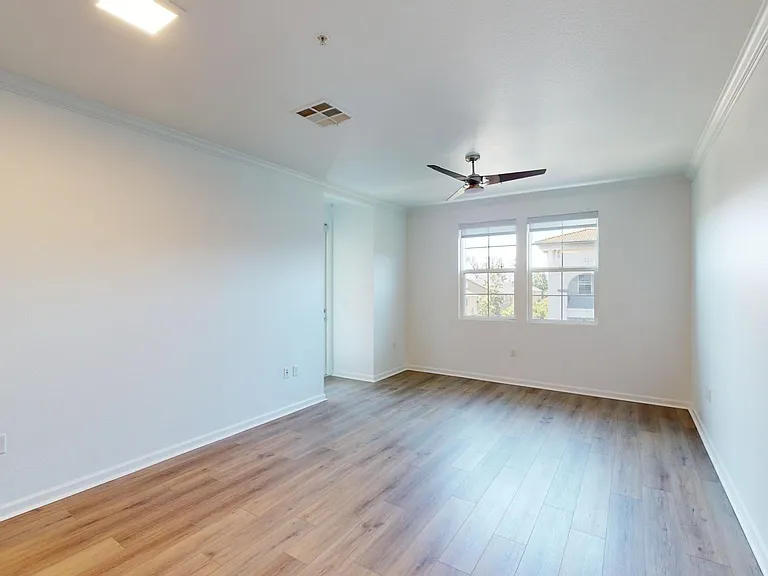 Apartment Living Room with Wood Style Flooring and Large Windows.