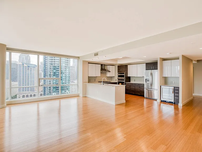 Open concept floor plan with luxury vinyl plank flooring, and floor to ceiling windows