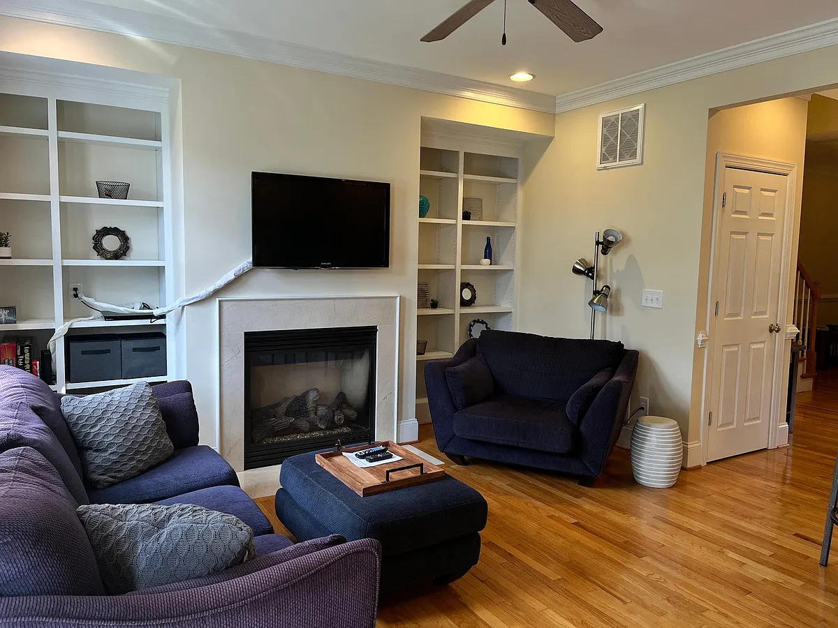 Living area with gas fireplace and TV - 8118 W End Dr