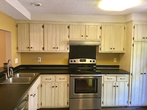 Bright kitchen with stainless steel appliances.