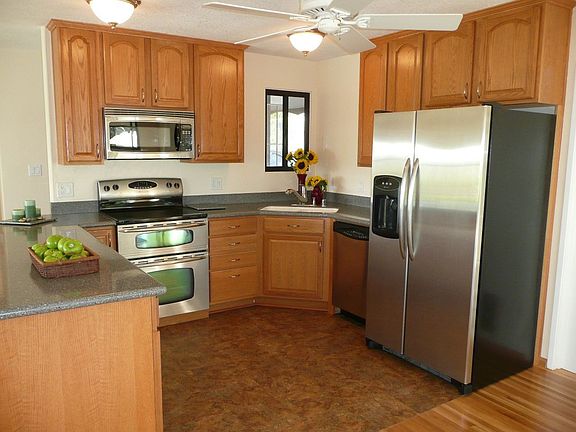 Brand new kitchen with Corian countertops, steel appliances and dining counter