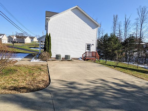 Large paved drive and Trane heat pumps for each level