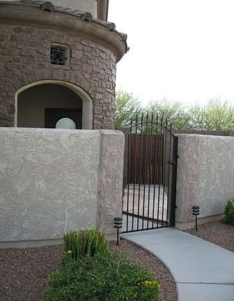 Gated entrance leads to privagte courtyard