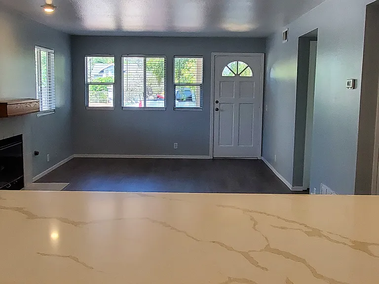 Livingroom and front door from kitchen and quartz breakfast bar