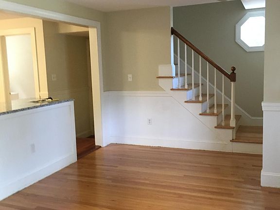stairway to upstairs, coat closet on bottom of stairway, kitchen counter to the left