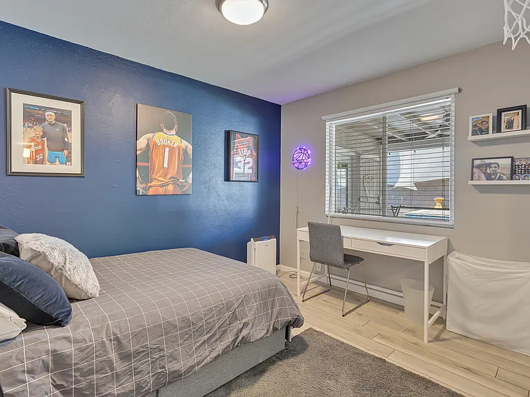 Bedroom currently set up as an office with full-size bed and workspace