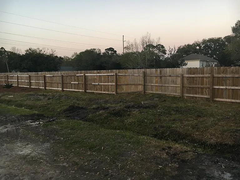 Privacy fence creating additional privacy for local neighbor with acres of undeveloped green space.