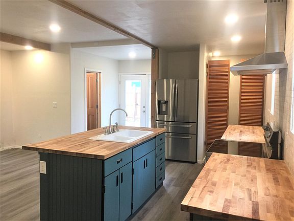 Kitchen in foreground with guest bath and entry in far view.