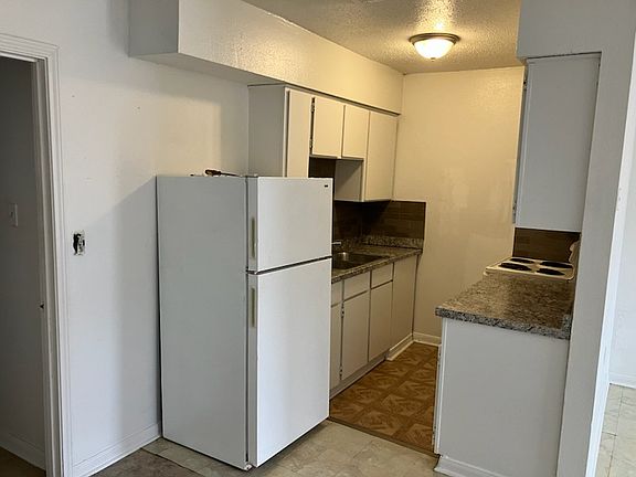 kitchen area, flooring, tile, counters, fridge can all be slightly different depending on apartment.