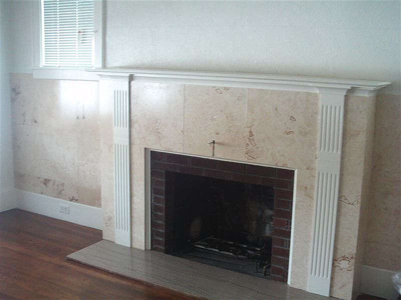 Fireplace in living room with hardwood floor