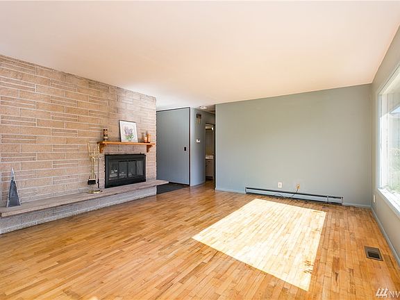 Living room seen from opposite direction, towards full bath and master beyond.  The room glows with sunlight.