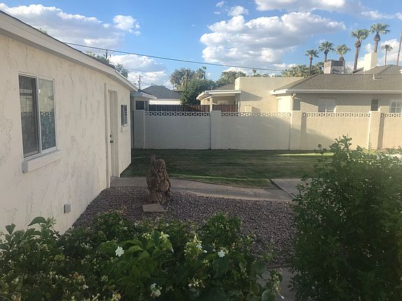 Outside: Backyard in the afternoon, looking north and showing door to work room