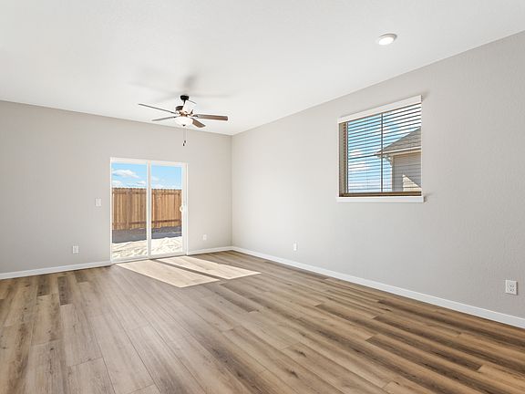 The family room is spacious with a ceiling fan.