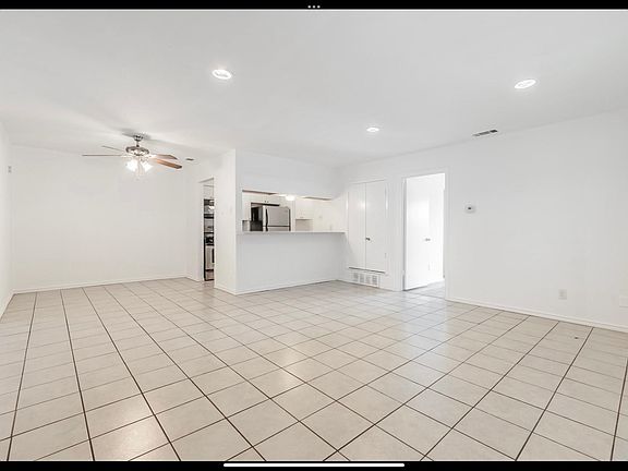 open kitchen with fresh paint, shaker cabinets and stainless appliances
