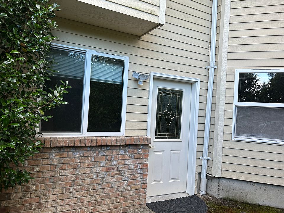 Private entrance with a sitting area to right surrounded by trees