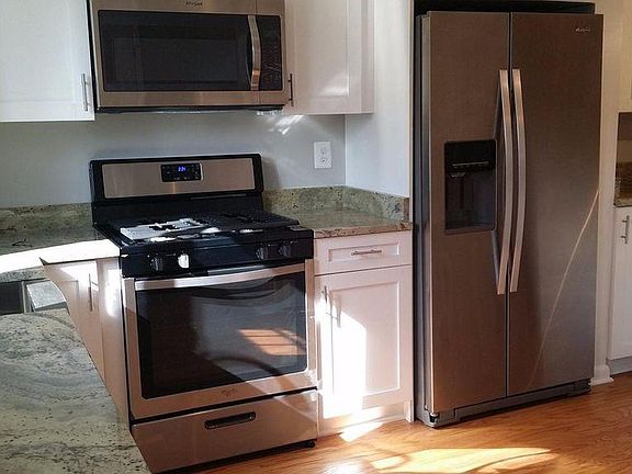 Gas range with granite counter tops and hardwood floors