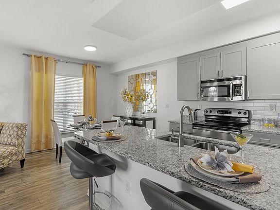 Renovated I Kitchen and dining area with hard-surface vinyl plank flooring
