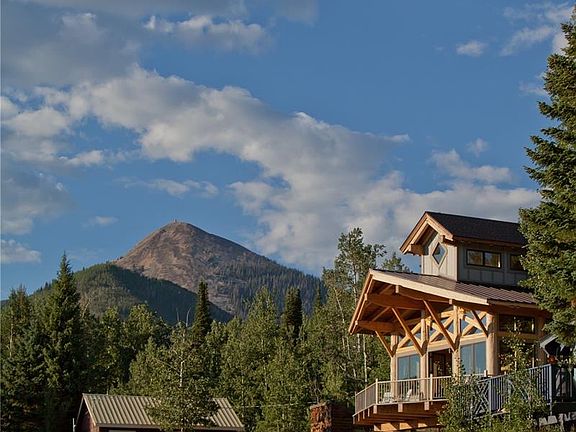 Hahns Peak guards the village