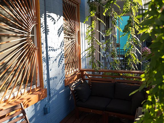 Sunny front porch, shaded by native wisteria vines.