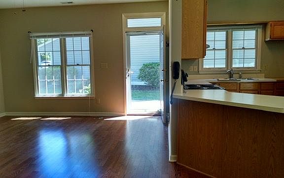 Great room with gleaming wood laminate floors and large windows
