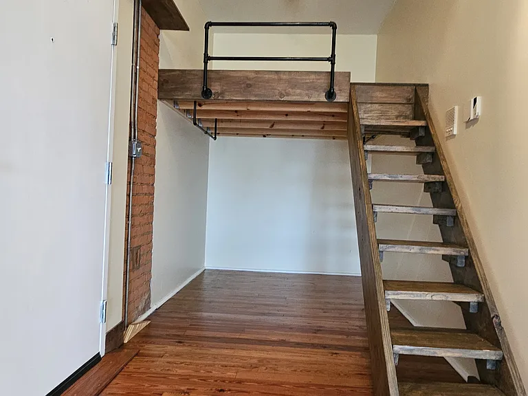 Cool lofted bed spot with clothes rods underneath.