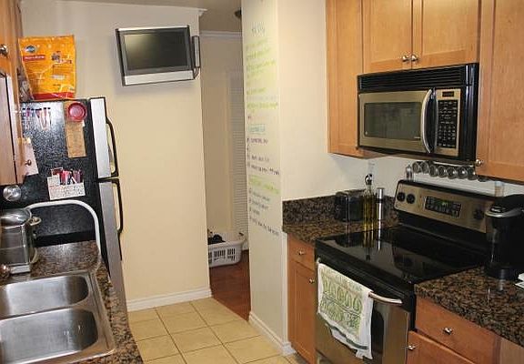Kitchen with white board wall.
