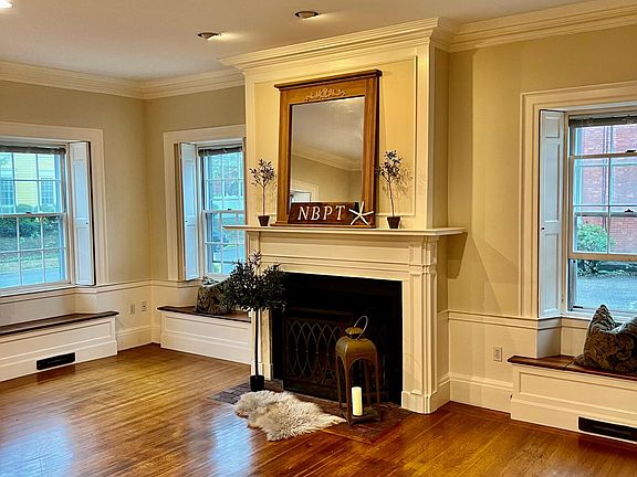 Spacious living room with Indian Shutters, high ceilings, Fireplace and Window Seats galore.