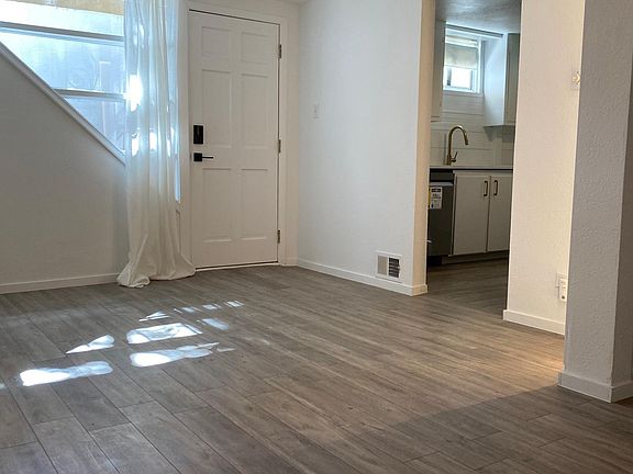 Living room w/ adjoining kitchen