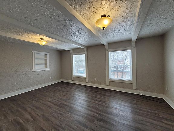 Living room with built in shelving and views of the Leonard corridor.