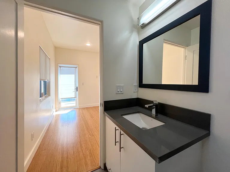 35. Rear Bathroom Sink and Vanity Cabinet