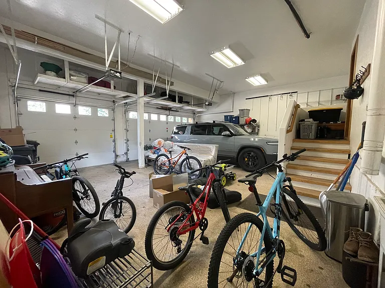 Three car oversized garage with storage on upper area and epoxy floors